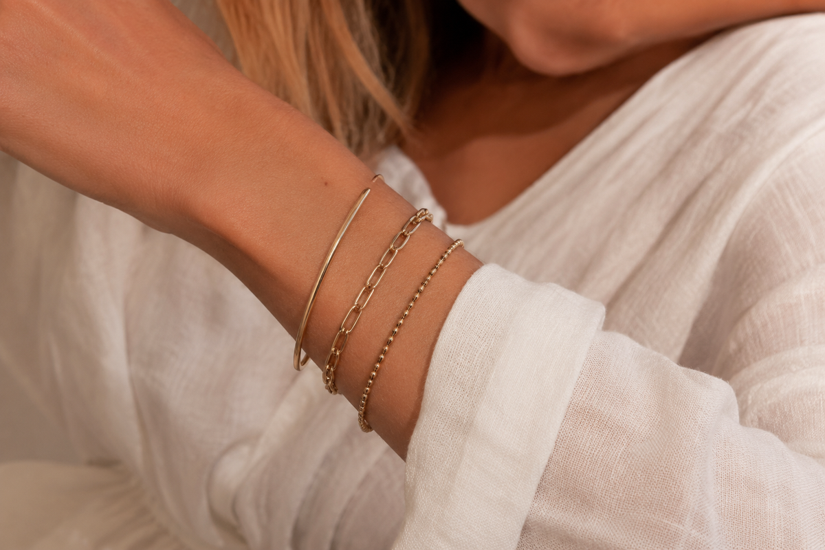 Gold stainless steel cuff and chain bracelets styled for a wholesale bracelet collection