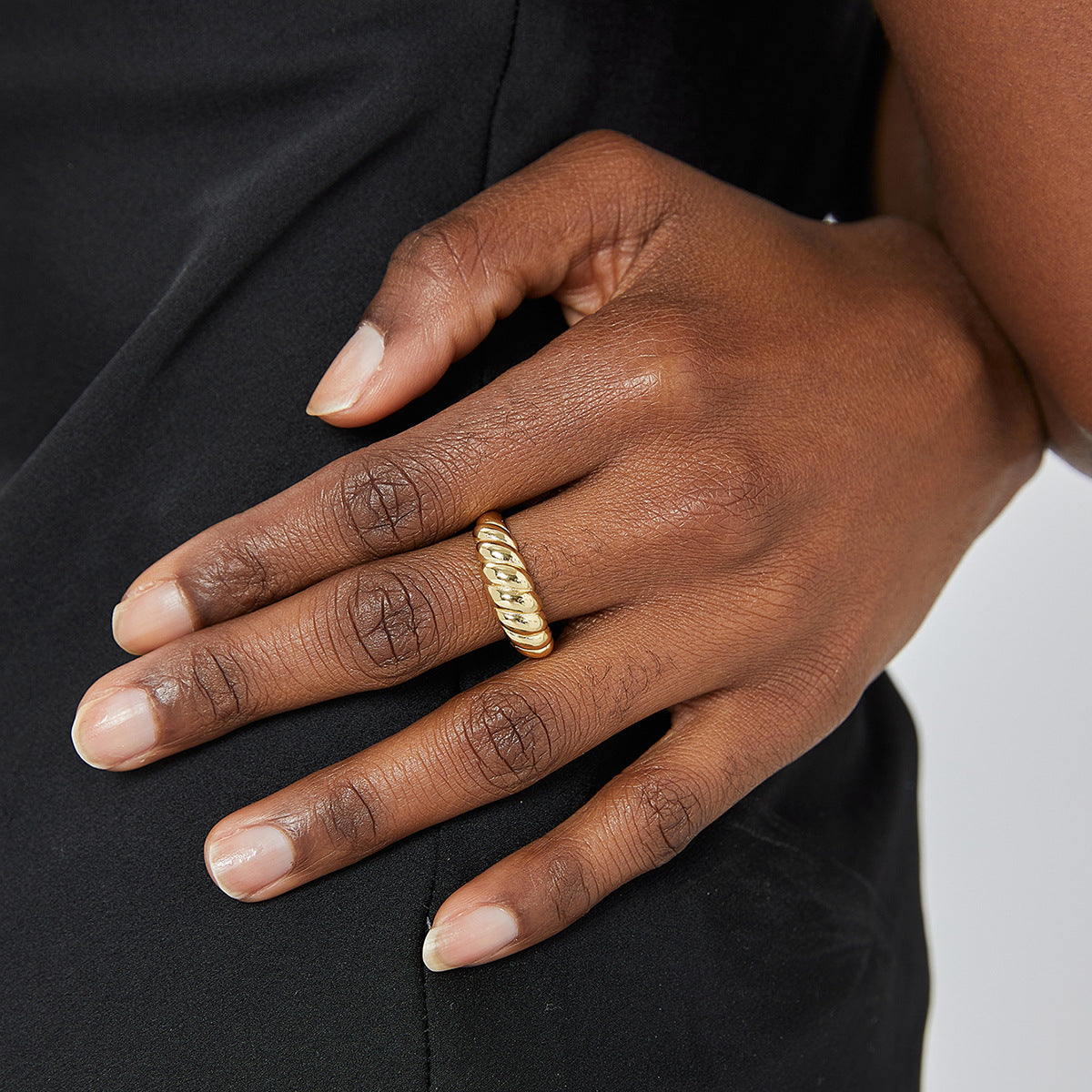 brass earring wearing on the finger