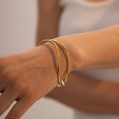 18K Gold-Plated Brass Sculptural Asymmetric Bracelet with Statement Detail in a gold-tone brass finish