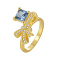 Gold-Plated Brass Knot Blue CZ Ring featuring cubic zirconia and a gold-tone finish