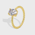 Gold-Plated Brass Twisted CZ Ring with Cubic zirconia Detail in a gold-tone brass finish