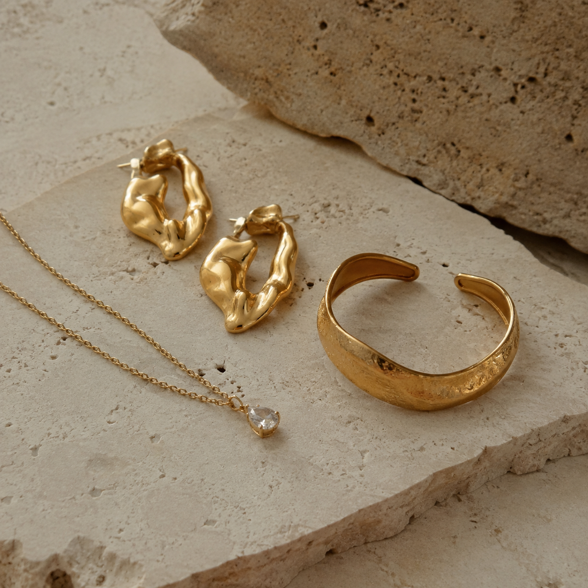 Custom gold-plated brass sculptural earrings, cubic zirconia necklace and fashion bracelet