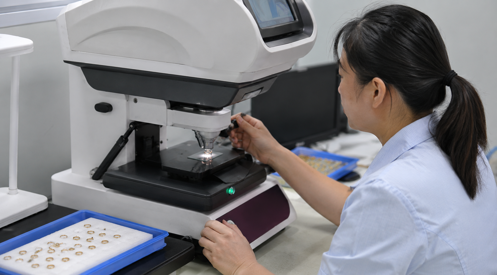 Chinese quality technician checking custom jewelry plating thickness with XRF equipment