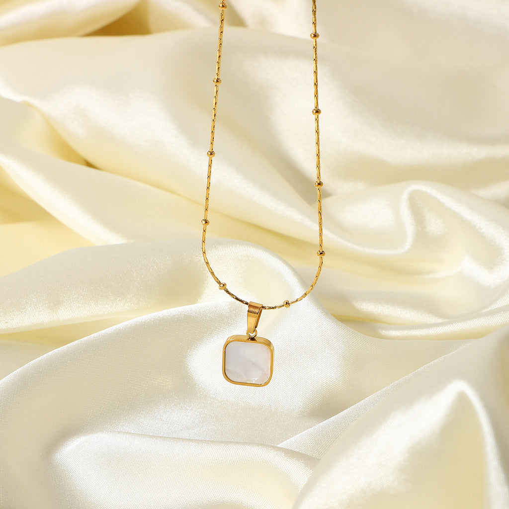 Gold-Plated Brass Shell Necklace featuring chain detailing