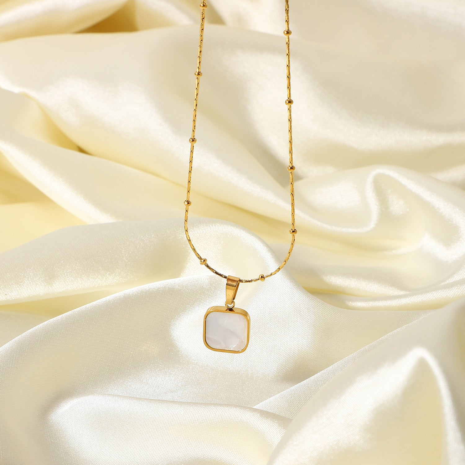 Gold-Plated Brass Shell Necklace featuring chain detailing